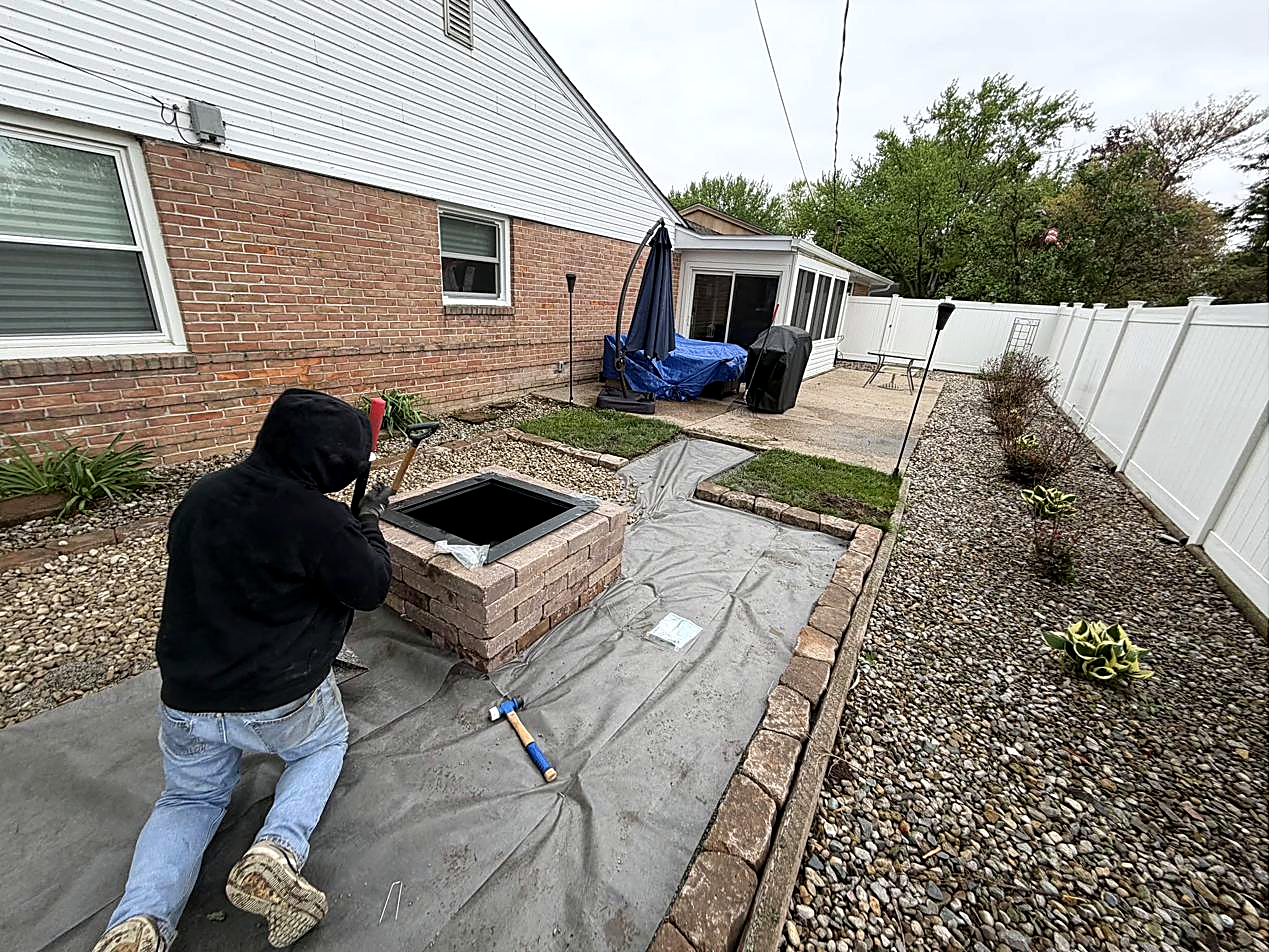 Home with white rock landscaping and potted plants