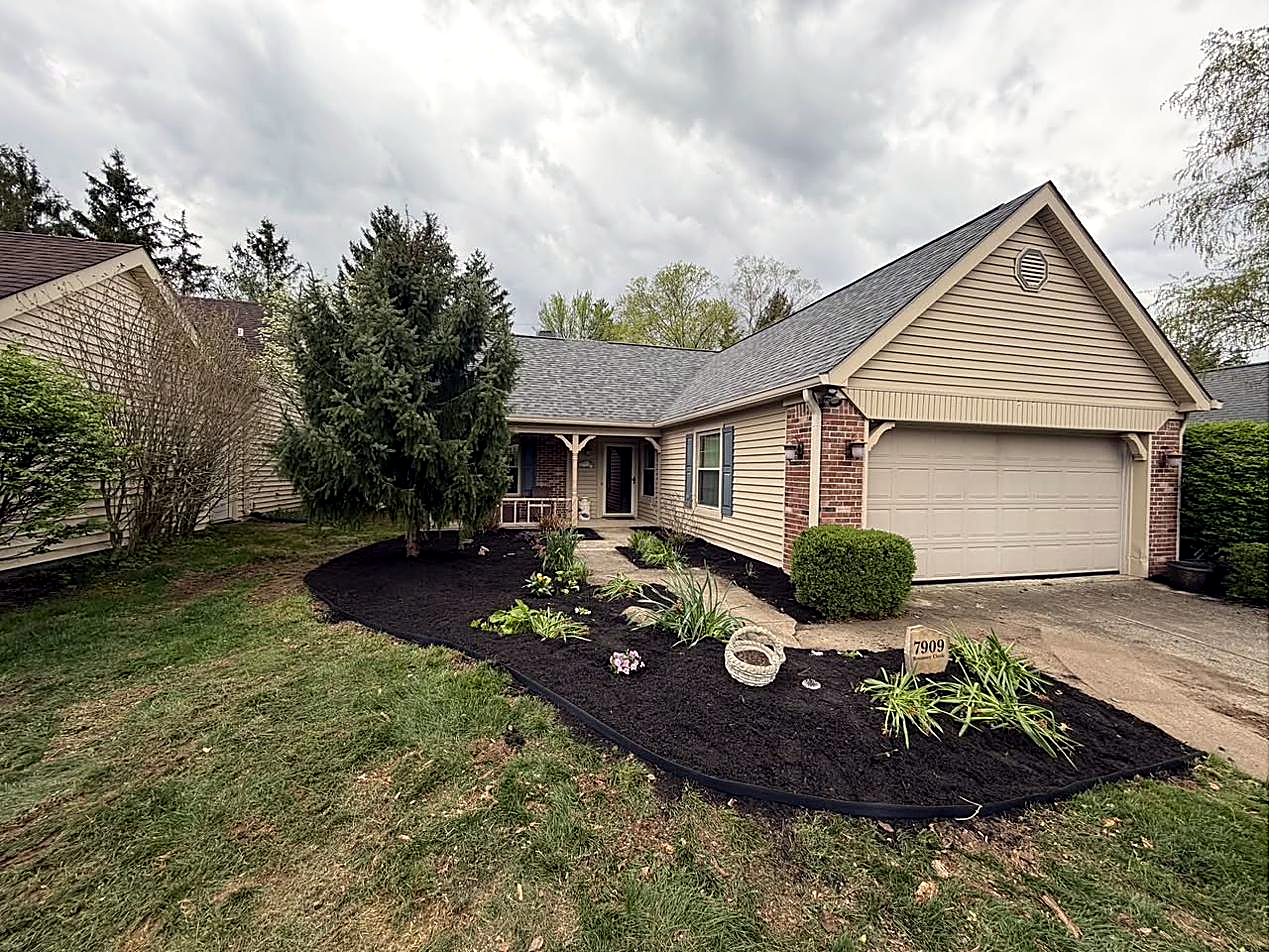 Home with white rock bed and plantings